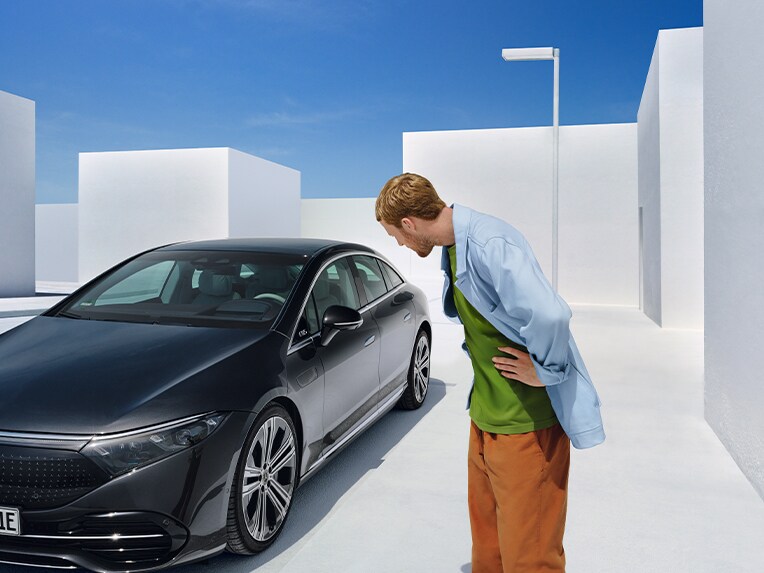 一名位於 Mercedes-Benz 車前的男仕。