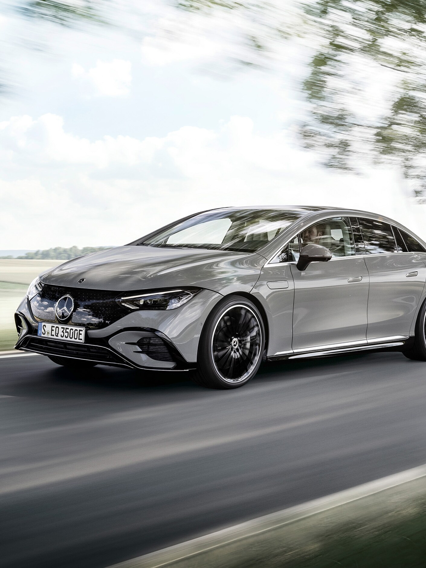 Side front view of an EQS on a country road